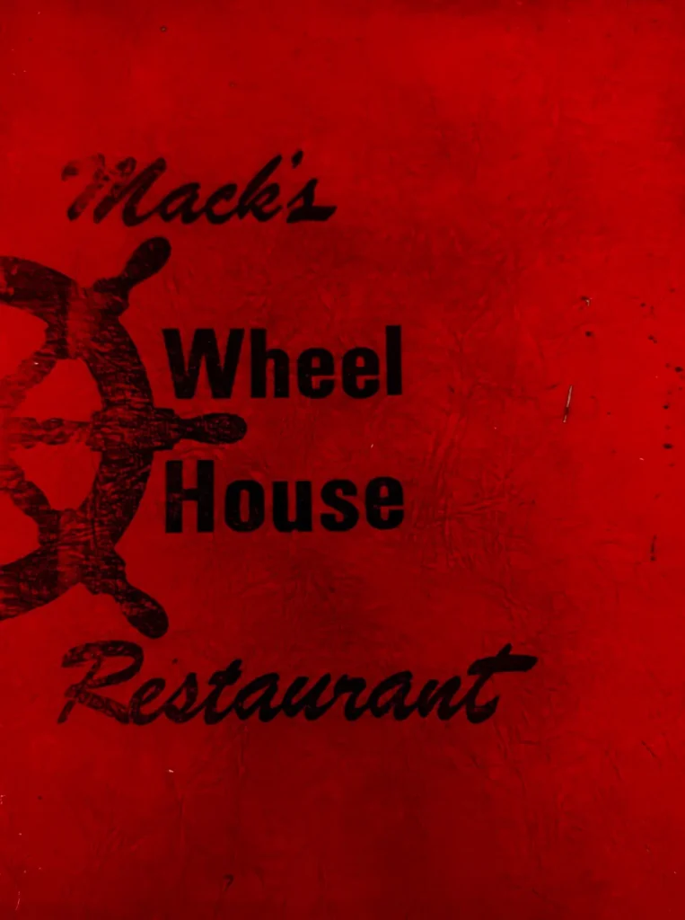The original menu cover from Mack's Wheel House Restaurant, deep red with a ship's wheel and Mack's written in script