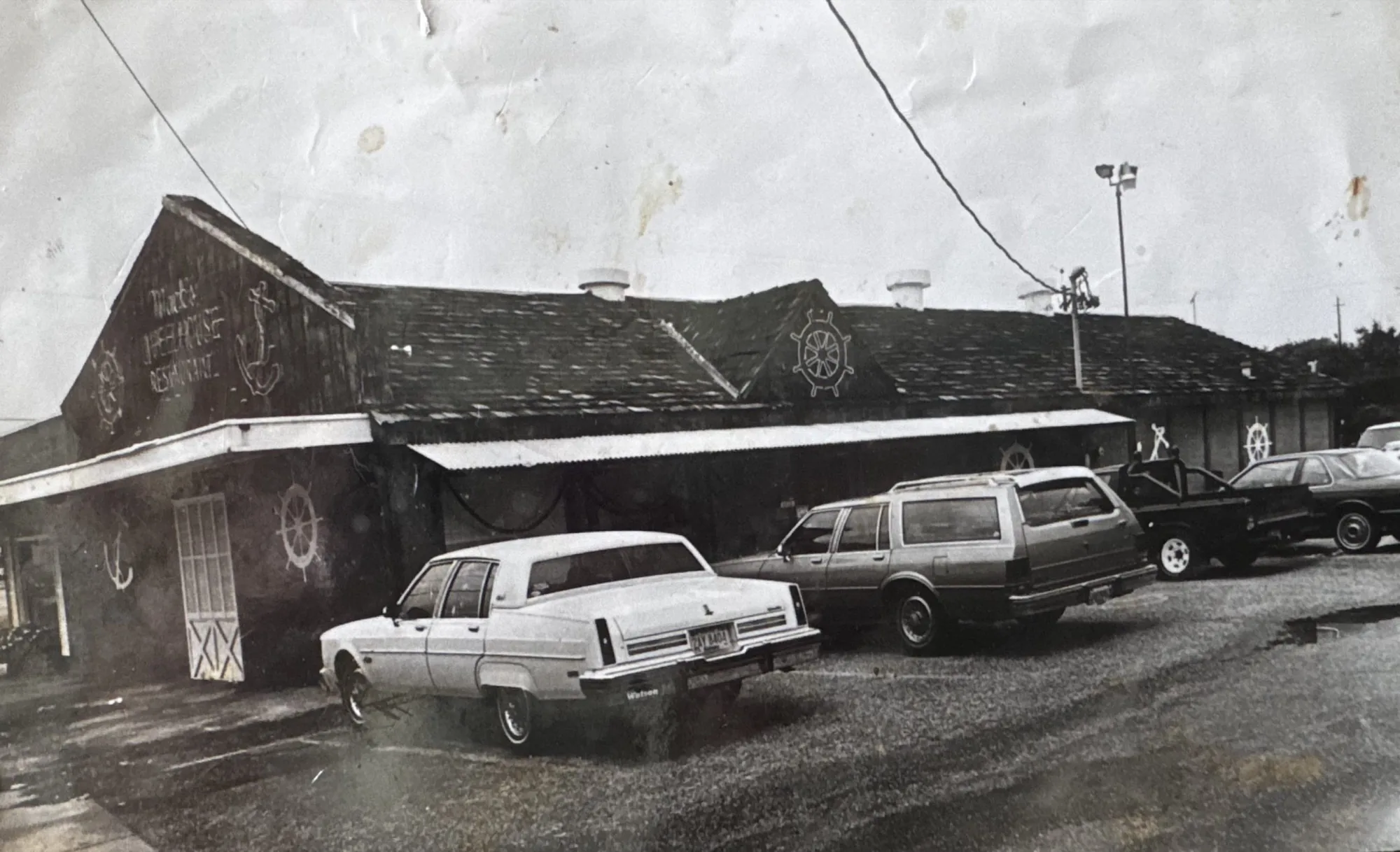 The original Mack's WheelHouse restaurant building, with cars parked out front