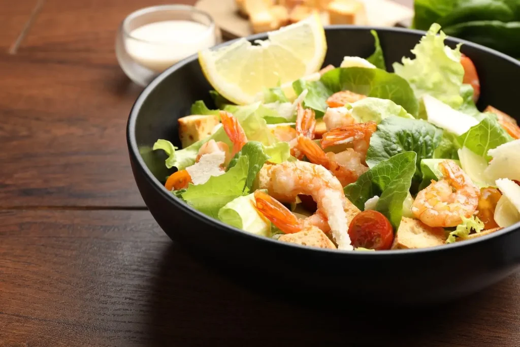 A shrimp salad with croutons and parmesan, dressed with Mack's Tartar and Salad Dressing