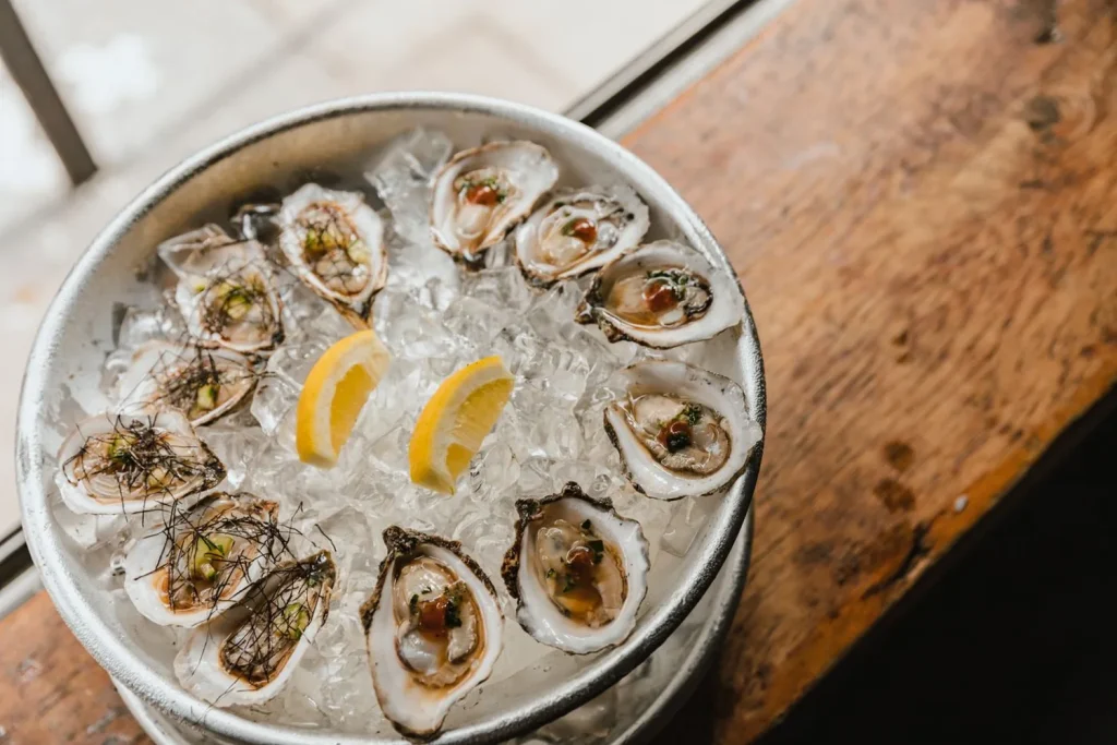 Oysters on the half shell over ice with lemon